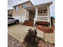 Charming two-story home with landscaped yard and a cozy front porch at 20308 E 48Th Dr, Denver, CO 80249