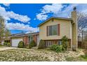 A beautiful exterior view of the home with mature landscaping, driveway, and attached two-car garage at 4640 Fairplay Way, Denver, CO 80239