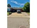 Wide driveway leading to garage of brick home, providing ample parking space and convenient access at 10425 Franklin Way, Northglenn, CO 80233