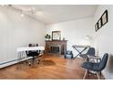 Cozy home office space with hardwood floors and a brick fireplace at 3465 S Poplar St # 406, Denver, CO 80224