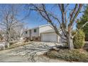 View of the side of a split level home showing siding and a two car garage at 18056 E Mansfield Ave, Aurora, CO 80013