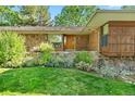 Inviting front entrance showcasing a stone facade, a wood door, and well-maintained landscaping at 5736 S Ivy St, Greenwood Village, CO 80111