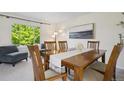 Bright dining room with wood table, modern art, and sunlit window at 1791 S Laredo St, Aurora, CO 80017