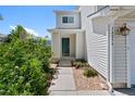 Charming home entrance with green door, low maintenance landscaping and covered entry at 16256 E Otero Pl, Englewood, CO 80112