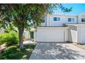 Inviting townhome with attached garage, mature shade tree and lush green lawn at 16256 E Otero Pl, Englewood, CO 80112