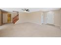 Spacious living room with neutral carpet, ceiling fan and staircase to second level at 16256 E Otero Pl, Englewood, CO 80112