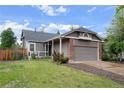 Charming single Gathering home featuring a covered porch, brick accents, and an attached two car garage at 3844 S Gibralter St, Aurora, CO 80013