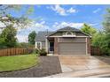 A well maintained single Gathering home with brick accents, a two car garage and manicured lawn at 3844 S Gibralter St, Aurora, CO 80013