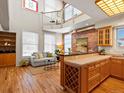 Bright, open loft featuring a living area with hardwood floors, exposed brick, and natural light streaming in from the windows at 225 N Lincoln St # 4, Denver, CO 80203