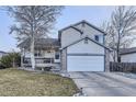 Charming two-story home featuring a two car garage, stone accents and beautifully landscaped front yard at 2482 Purcell Pl, Brighton, CO 80601