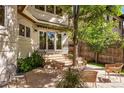 Relaxing backyard patio area with wicker furniture, surrounded by trees and privacy fence at 1035 S Elizabeth St, Denver, CO 80209