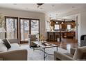 Open living room with hardwood floors, neutral furniture, and natural light flowing in at 1035 S Elizabeth St, Denver, CO 80209