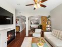 Spacious living room flowing into the dining area, featuring hardwood floors and a cozy fireplace at 1747 N Pearl St # 306, Denver, CO 80203