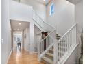Bright entryway with soaring ceilings, hardwood floors and a staircase with white railings at 1168 Basalt Ridge Loop, Castle Rock, CO 80108