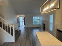 Bright living room featuring a fireplace, large windows, and modern lighting fixtures at 4348 Sable St, Denver, CO 80239