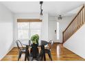 Sunlit dining room featuring hardwood floors and a contemporary chandelier at 24505 E Wagon Trail Ave, Aurora, CO 80016