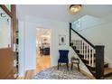 Bright foyer with hardwood floors, stylish staircase, and a glimpse into the modern kitchen at 1519 16Th St, Boulder, CO 80302