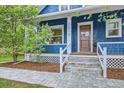 Inviting blue home with a craftsman-style wood front door, decorative lattice, and stone path at 1519 16Th St, Boulder, CO 80302