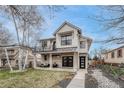 Stunning two-story home with a covered porch, balcony, and modern farmhouse design elements at 2948 S Clarkson St, Englewood, CO 80113