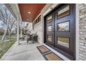 Inviting front porch with comfortable seating, stylish decor, and a modern front door at 2948 S Clarkson St, Englewood, CO 80113