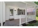 Close-up of the home's front porch, featuring a white railing and brick facade at 740 Cherry St, Denver, CO 80220