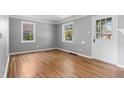 Bright living room with hardwood floors and ample natural light from two large windows at 740 Cherry St, Denver, CO 80220