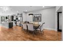 Elegant dining room with hardwood floors, stylish chandelier, and seating for six at 2523 N Humboldt St, Denver, CO 80205