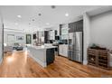 Modern kitchen with stainless steel appliances, a large island, and hardwood floors at 2523 N Humboldt St, Denver, CO 80205