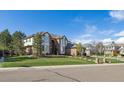 Traditional brick home with a well-maintained lawn and mature trees at 9188 Buck Hill Dr, Highlands Ranch, CO 80126