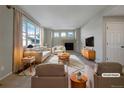 Bright living room features a cozy fireplace and large windows providing lots of natural light at 342 Olympia Ave, Longmont, CO 80504