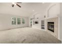 Bright living room featuring a fireplace, built-in shelves, and large windows with outdoor views at 8267 S Sicily Ct, Aurora, CO 80016