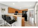 Traditional kitchen with wooden cabinets, granite countertops and a bar with seating for casual dining at 3090 W 107Th Pl # F, Westminster, CO 80031