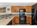 A kitchen showcasing light wood cabinetry, tile backsplash, and modern appliances at 3090 W 107Th Pl # F, Westminster, CO 80031
