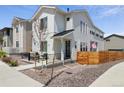 Charming two-story home featuring modern farmhouse architectural details and a cozy front porch seating area at 10534 Oncilla Ln, Lone Tree, CO 80124