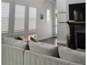 Bright living room with white shutters and a comfortable neutral couch at 10534 Oncilla Ln, Lone Tree, CO 80124