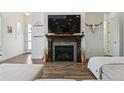 Inviting living room with a stone fireplace, a large TV and a cozy sitting arrangement at 10534 Oncilla Ln, Lone Tree, CO 80124
