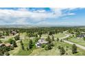 Expansive aerial view of the property, showcasing its generous lot size, mature trees, and scenic views at 5542 Ponderosa Dr, Parker, CO 80134