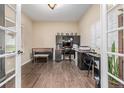 Spacious home office with dark wood floors, an executive desk, and a view of the outdoors at 28495 La Donna Vista Ln, Elizabeth, CO 80107
