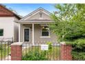 Inviting home showcasing a cozy front porch and wrought-iron fence for curb appeal at 2841 Stout St, Denver, CO 80205