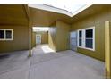 Covered courtyard featuring a white door, and white windows with a view to another area of the property at 5350 E 66Th Way, Commerce City, CO 80022