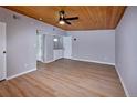 Bright living room featuring hardwood floors, paneled ceiling, and modern lighting fixture at 5350 E 66Th Way, Commerce City, CO 80022