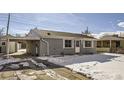 Ranch home with carport and snow-covered yard at 13610 E 13Th Pl, Aurora, CO 80011