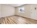 Bright living room with hardwood floors and large window at 13610 E 13Th Pl, Aurora, CO 80011