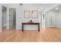 Inviting entryway with light hardwood floors, clean lines, and minimalist decor at 3049 S Vine St, Denver, CO 80210
