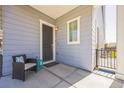 Cozy front porch featuring a chair and a small table near the front door at 12574 Lake View St, Longmont, CO 80504