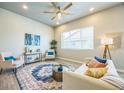 Comfortable living room featuring hardwood floors, contemporary decor, and a ceiling fan at 12574 Lake View St, Longmont, CO 80504