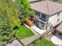 Aerial view of a home's backyard featuring a wooden deck, green grass, and gravel landscaping at 13895 Sandtrap Cir, Broomfield, CO 80023