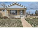 Charming brick home with a cozy front porch and neat landscaping, offering a welcoming curb appeal at 283 Garland Dr, Northglenn, CO 80233