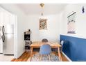 Cozy dining area features a wooden table with blue chairs, and stylish light fixture at 85 N Grant St # 30, Denver, CO 80203
