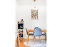 Inviting dining area features a wooden table with chairs, light fixture, and stylish decor at 85 N Grant St # 30, Denver, CO 80203